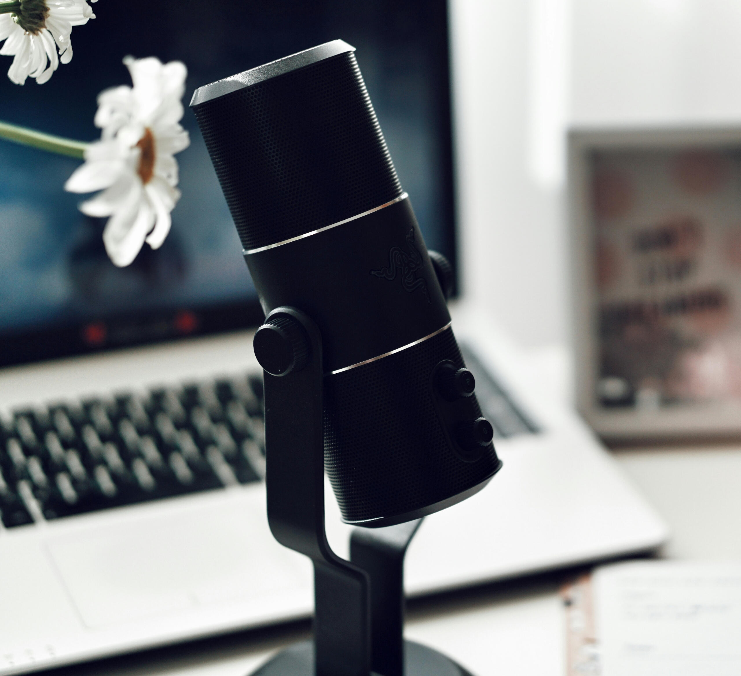 A photo of an interpreter microphone standing over a desk in front of a laptop.